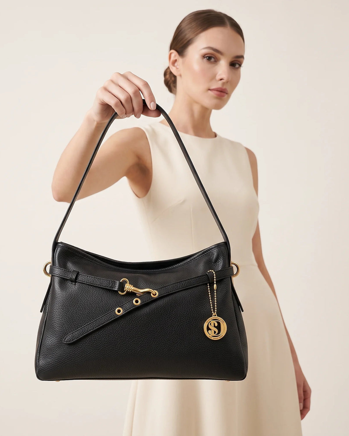 a woman holding a black leather bag