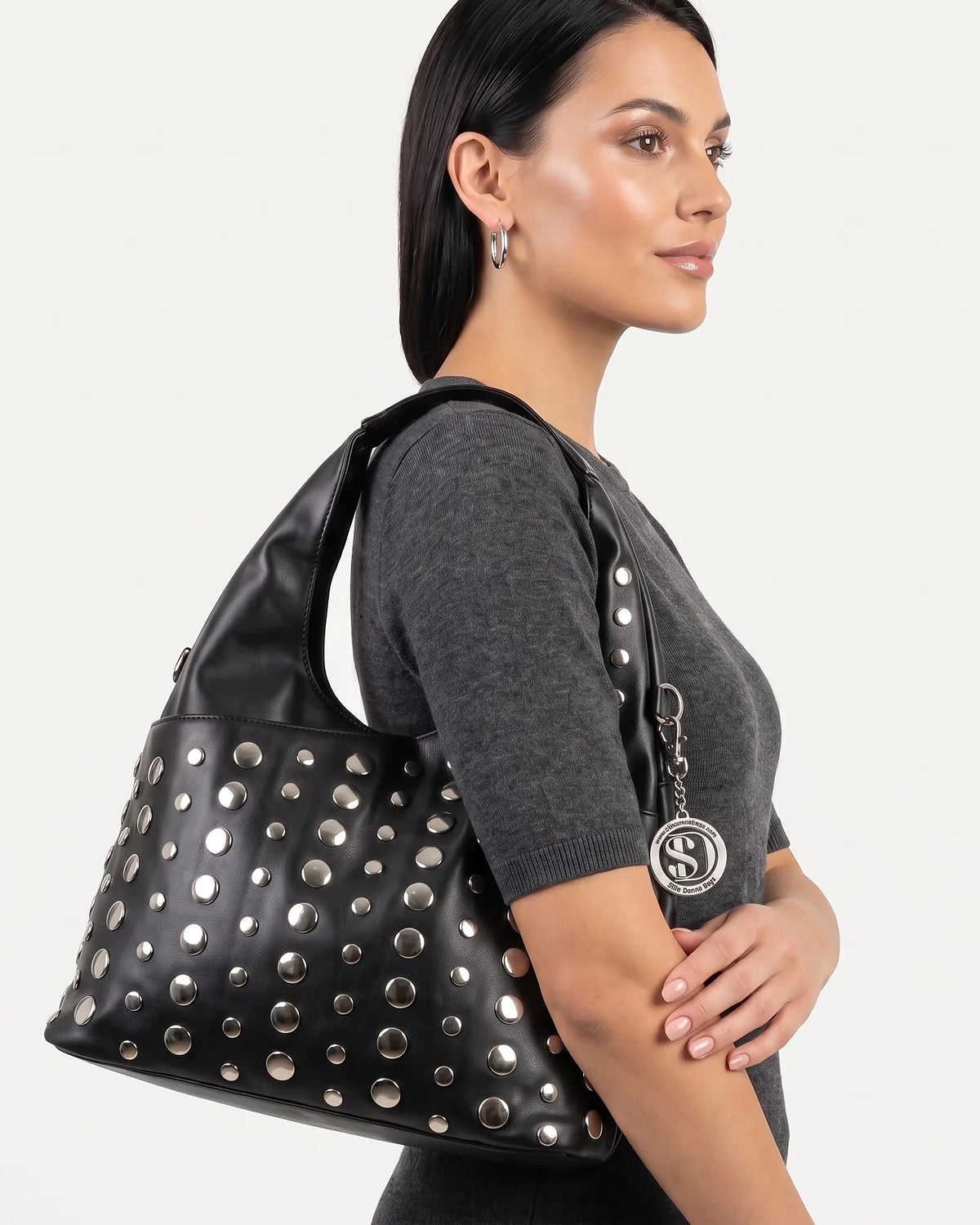 a female carrying a bag with silver details