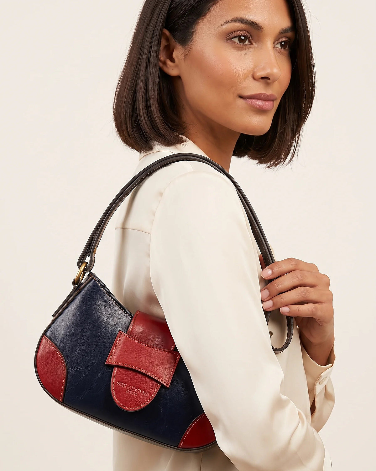 a woman holding a leather bag